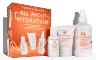 A product display of bumble and bumble hair care products, including shampoo, conditioner, and oil in labeled bottles, packaged together in a box titled "all about hydration.