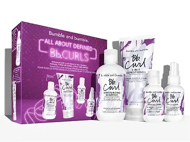 A product display of bumble and bumble bb.curls hair care set, featuring shampoo, conditioner, and other styling products in a purple and white package.