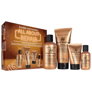 A boxed set of bumble and bumble hair repair products, featuring five bottles in various sizes, with a brown and gold design emphasizing hair treatment and restoration.