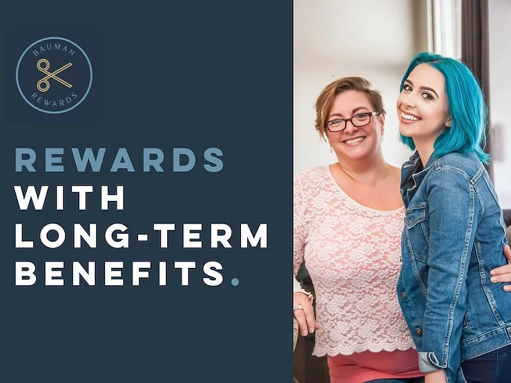 Two women smiling and embracing, one with blue hair, next to a text "rewards with long-term benefits. bauman & rewards.