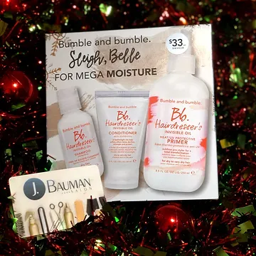 Holiday-themed promotional display for bumble and bumble hair care products including conditioner and primer, set against a background of red and green sparkling decorations. price labeled at $33.